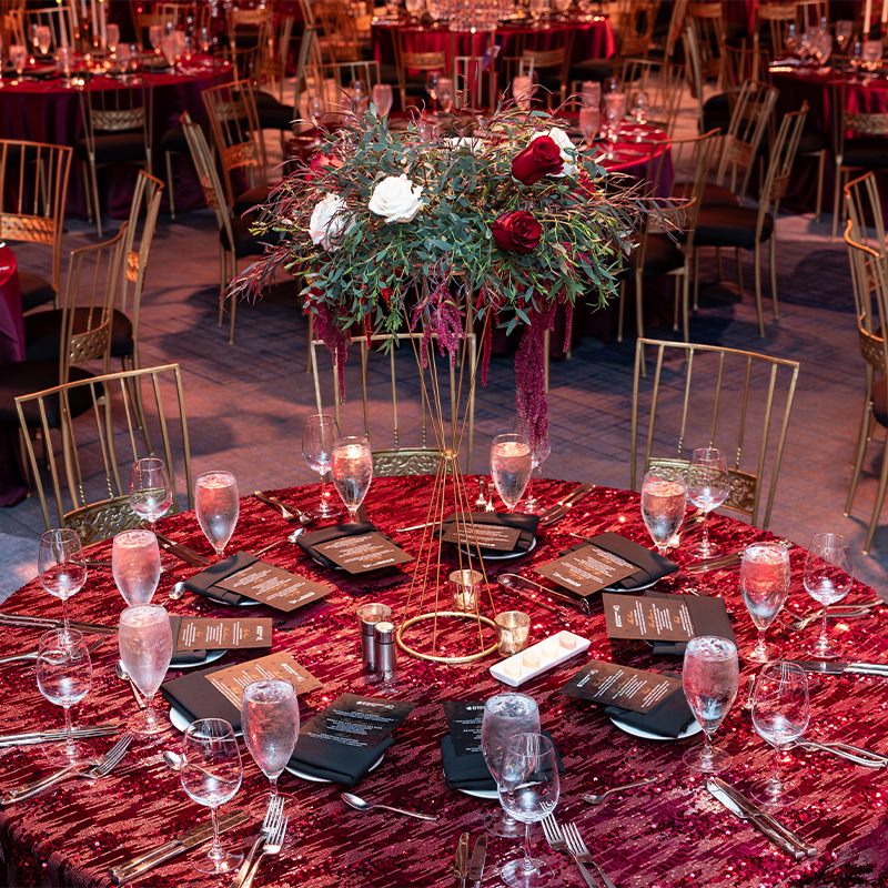 close-up of circular table in red cloth at an indoor Palm Springs awards gala