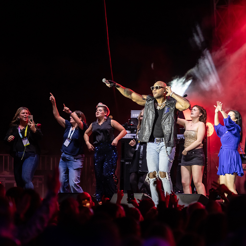 10 people on stage performing at a Palm Springs entertainment event