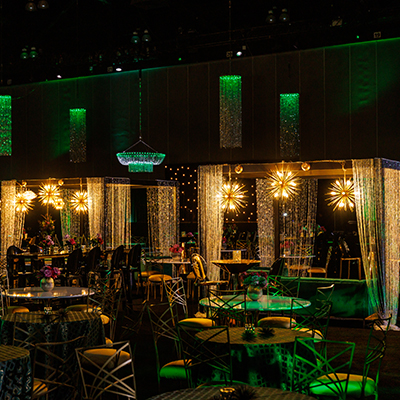Los Angeles reception event setup with gold accents and round tables in a dimly lit room