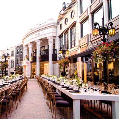 Rodeo Drive reception setup with long white tables in Beverly Hills, Los Angeles