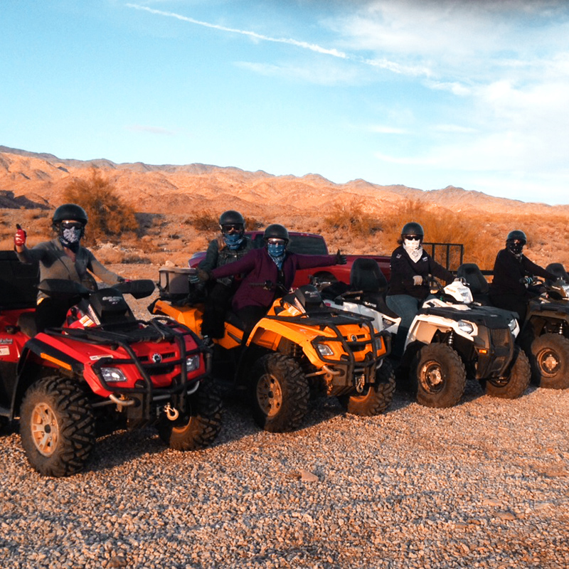 people riding ATVs on red rock desert