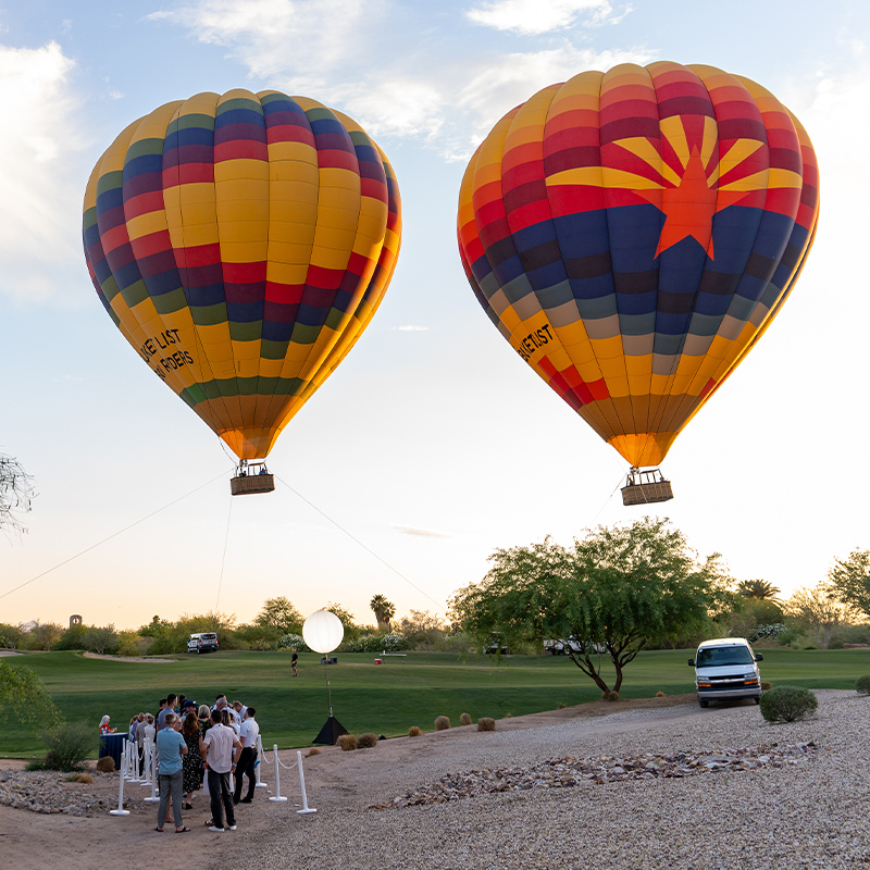 people waiting their turn to ride a hot air balloon