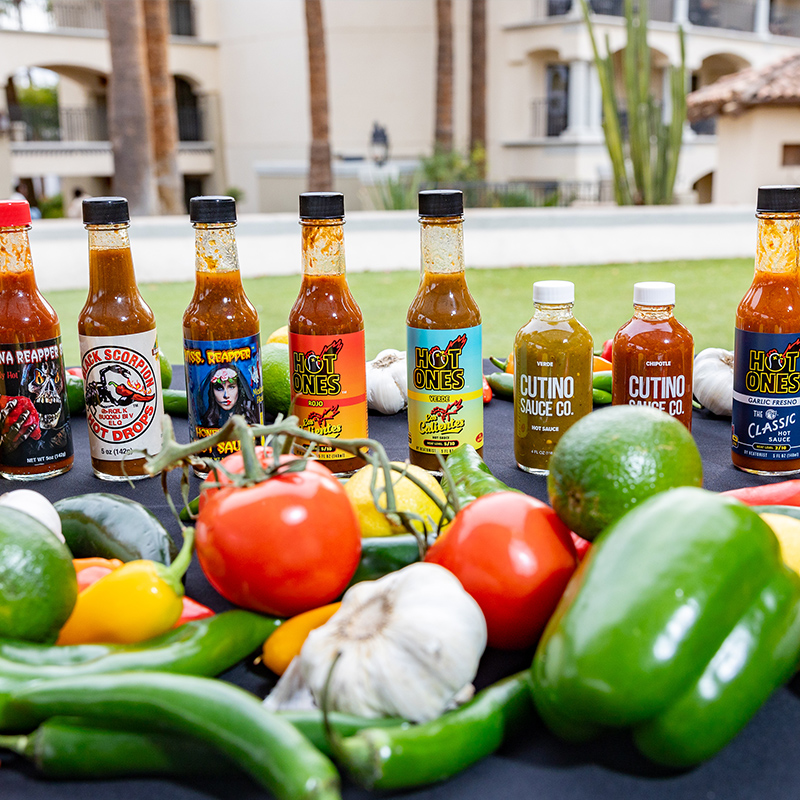 Sauces, spices and vegetables lined up on a table
