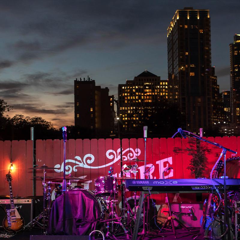 live music stage with sky scrapers in the background